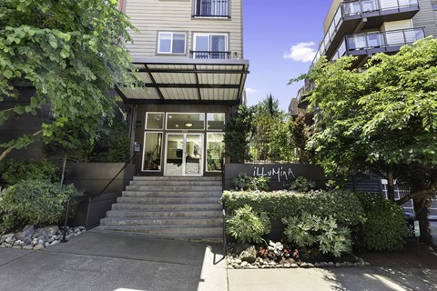 Property Entrance stairs with bushes surrounding the front of it  at Illumina Apartment Homes, WA 98102