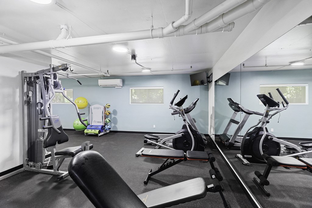 a gym with exercise equipment and a yellow exercise ball at King Arthurs Court, Seattle
