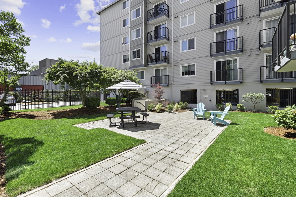 Resident community patio with outdoor lounge seating at King Arthurs Court, Washington, 98125