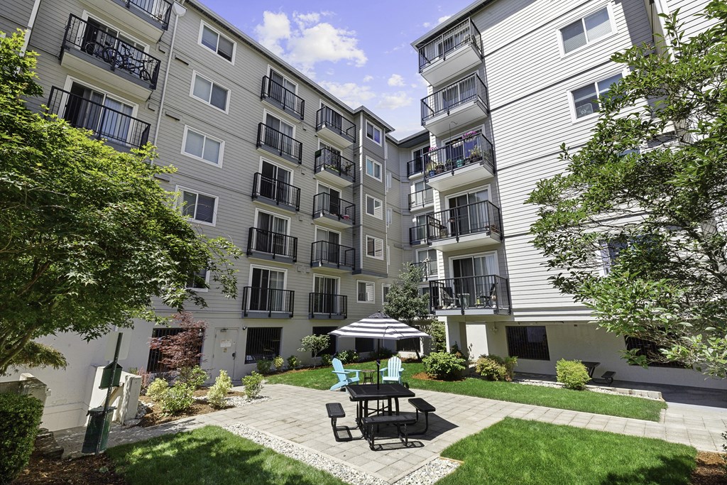 Resident Courtyard patio with a table and chairs at King Arthurs Court, Washington