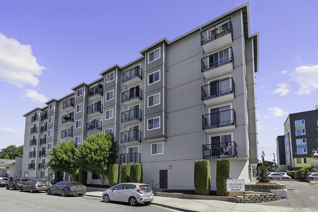 a picture of building exterior with cars parked in front of it at King Arthurs Court, Washington