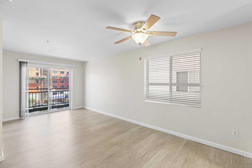 Spacious Living Area with hardwood flooring and a ceiling fan at Promenade at the Park Apartment Homes, Seattle, WA
