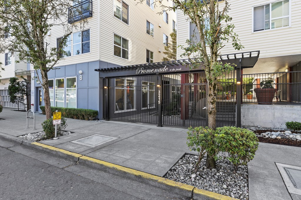 Property Entrance with black and white signage on the front at Promenade at the Park Apartment Homes, Seattle