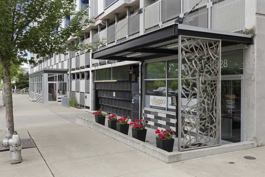 View of the property entrance from the side with artsy iron patio wall View of the property entrance from the side with artsy iron patio wall at Villaggio Apartment Homes, Tacoma, Washington 98402 - Photo Gallery
