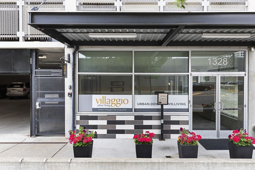 the exterior of the property with a black and white checkered tile and plants in front the exterior of the property with a black and white checkered tile and plants in front at Villaggio Apartment Homes, WA 98402 - Photo Gallery