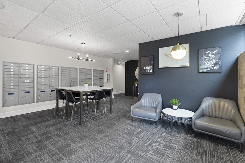 Cozy Lobby Area with a table and chairs and convenient mailboxes on the wall Cozy Lobby Area with a table and chairs and convenient mailboxes on the wall at Villaggio Apartment Homes, Tacoma, 98402