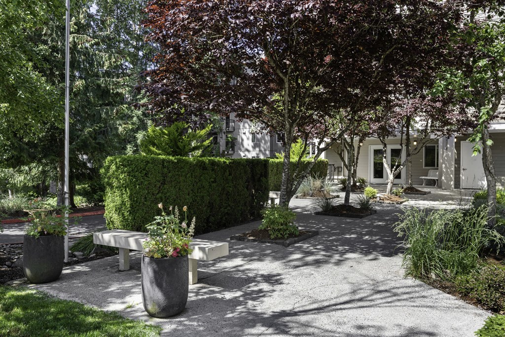 Property Courtyard with benches and planters in front for resident enjoyment at West Mall Place Apartment Homes, Everett, WA, 98208