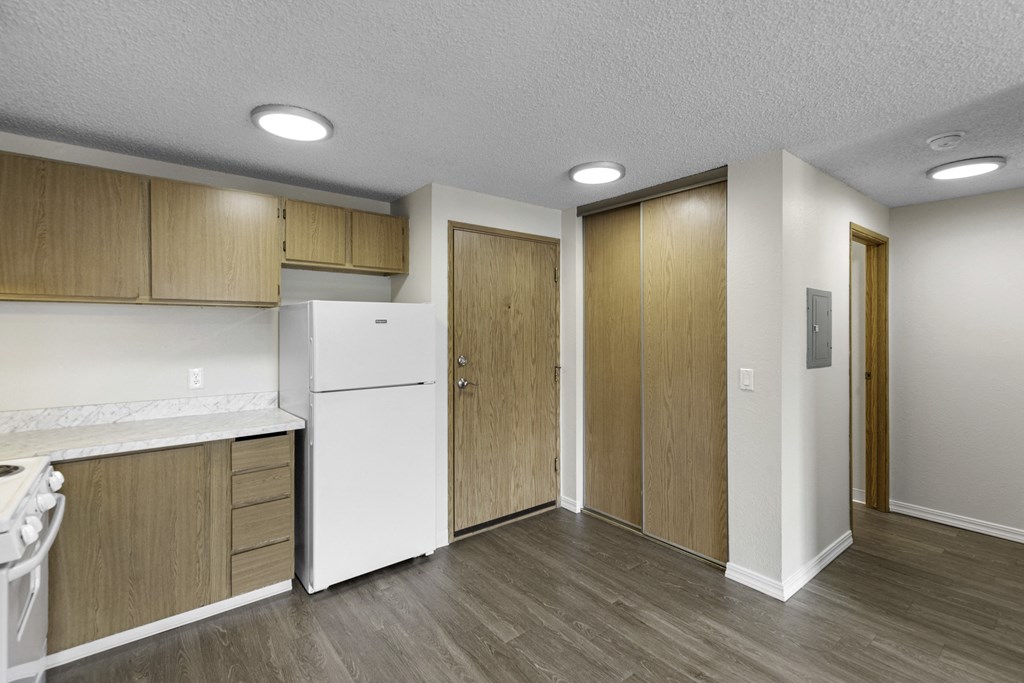 Very Spacious kitchen with a white refrigerator and freezer and wooden cabinetry at Willows Court Apartment Homes, Seattle, 98125