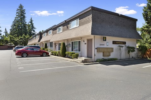 Side View of Townhomes with a White Building and Grey Roof at Woodlake Townhomes, Washington, 98026