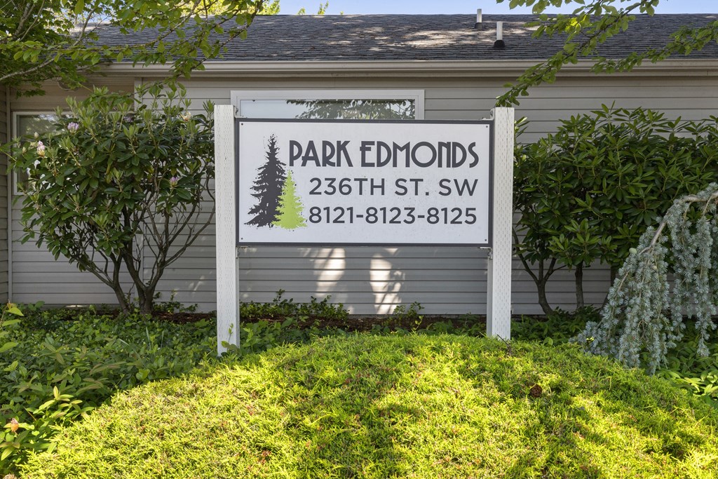 Property Sign surrounded by Green Grass and Trees at Park Edmonds Apartment Homes, Washington