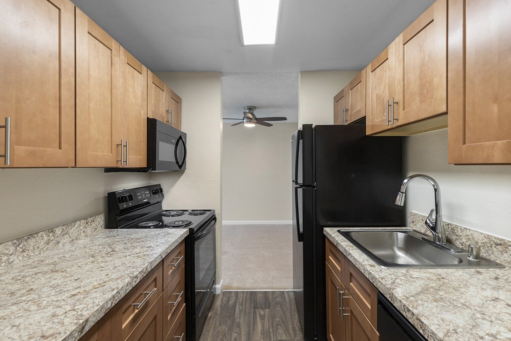 Kitchen with Plank Flooring and Wood Cabinetry at Park Edmonds Apartment Homes, Edmonds, 98026