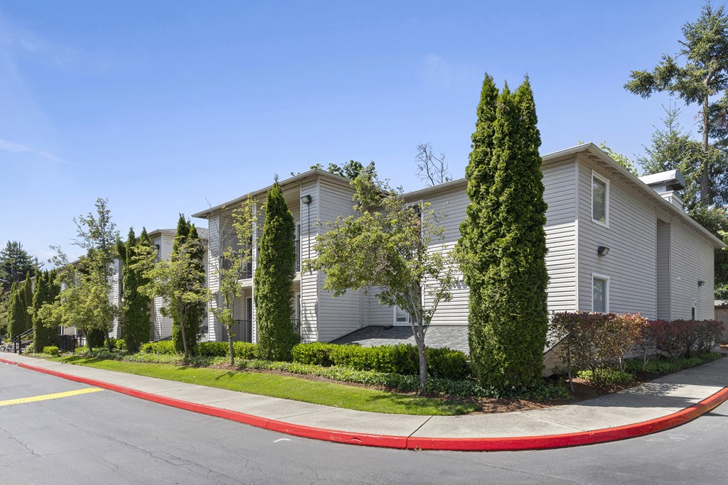 a street view of the property with landscaped trees at Park Edmonds Apartment Homes, Washington