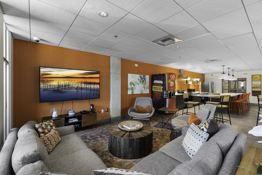 A Community Lounge Room filled with furniture and a large windows at Sedona Apartments, Seattle, Washington