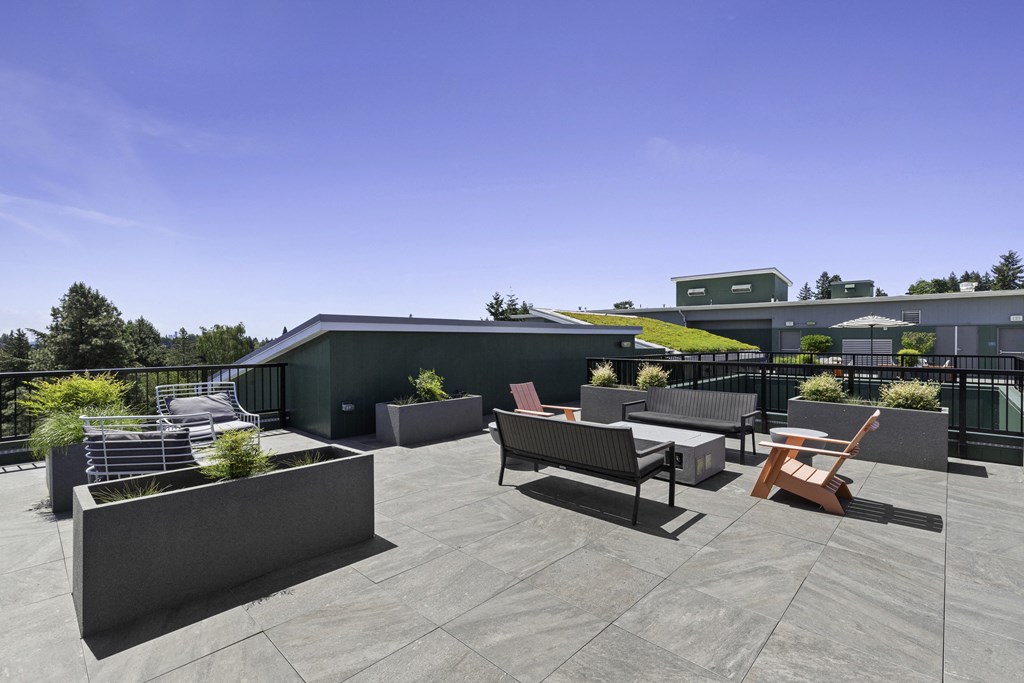 a rooftop patio with a green roof and a variety of seating and tables at Sedona Apartments, Seattle