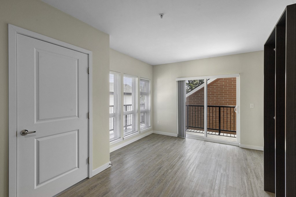 Apartment View of Living Area with sliding glass doors leading to a balcony at Sedona Apartments, Seattle