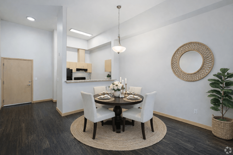 A dining room with a round table and chairs.