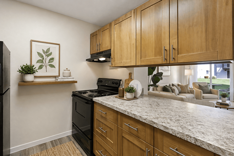 A kitchen with wooden cabinets and a granite countertop.