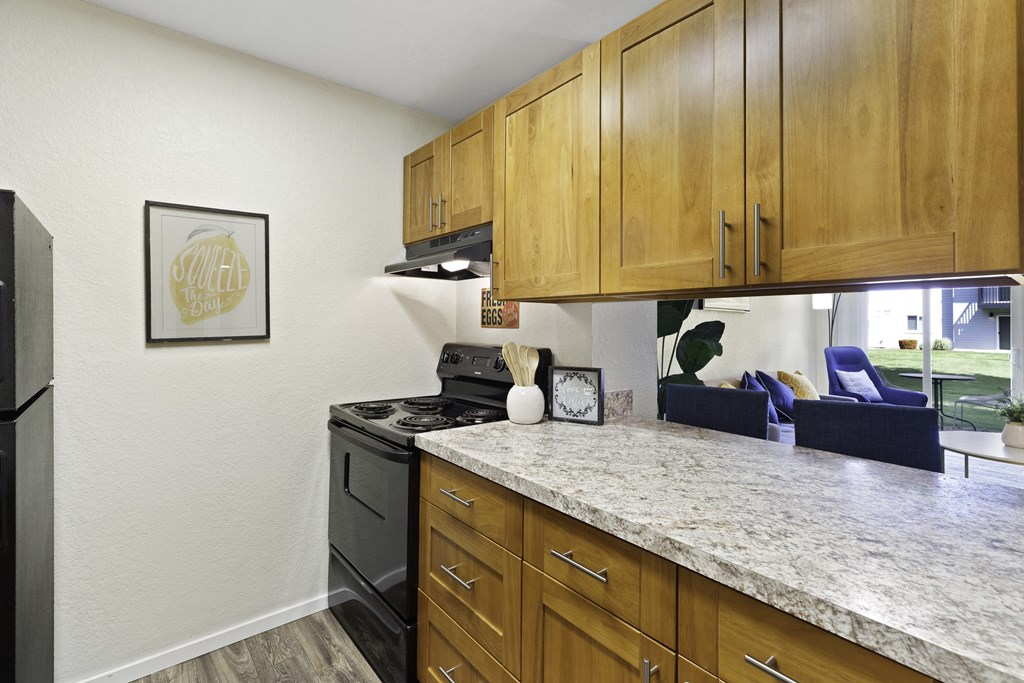 Kitchen with Plank Flooring, Efficient Appliances, and Light Brown Cabinetry at Pacific Park Apartment Homes, WA 98026