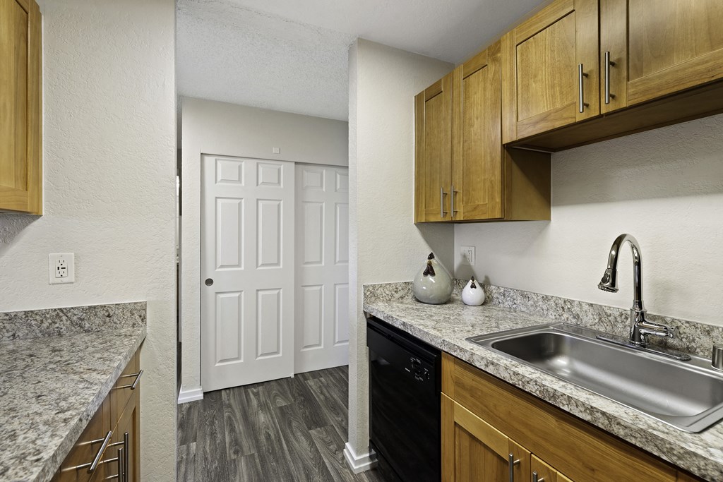 a kitchen with a sink and a dishwasher at Pacific Park Apartment Homes, Washington