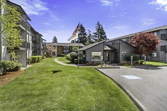 Grassy Courtyard Area with grass and Tress Outlining the Area at Pacific Park Apartment Homes, Edmonds, Washington 98026