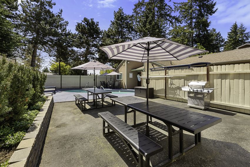 Resident Picnic Area with Picnic Tables and Striped Umbrellas Resident Picnic Area with Picnic Tables and Striped Umbrellas at Park 210 Apartment Homes, Edmonds, WA, 98026