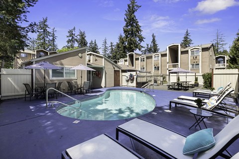 Resident Outdoor Swimming Pool with Lounge Chairs and Tree-shaded Areas at Park 210 Apartment Homes, Washington