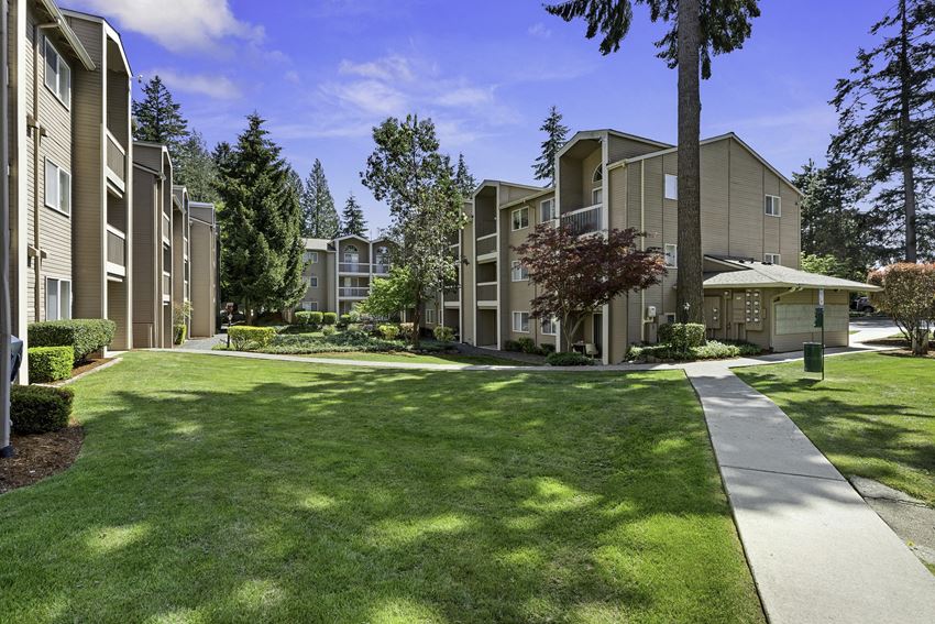 Apartment Buildings Surrounded by Grassy Area with Trees Apartment Buildings Surrounded by Grassy Area with Trees at Park 210 Apartment Homes, Washington, 98026
