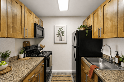 A kitchen with wooden cabinets and black appliances.