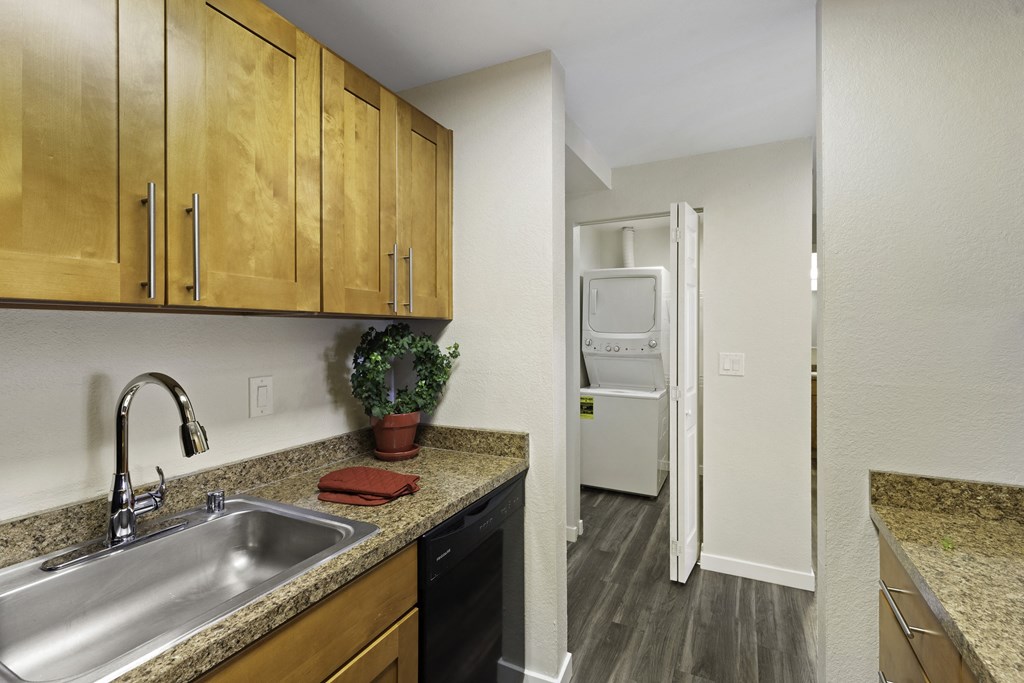 a kitchen with a sink and a washer and dryer