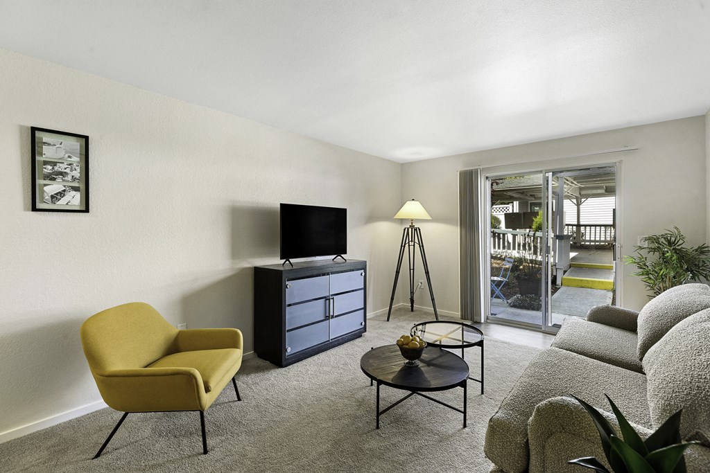 a living room filled with furniture and a flat screen tv