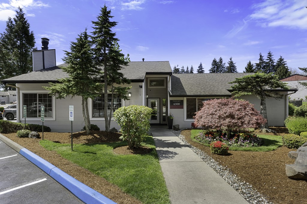 Stone Walkway Path Leading to Welcome Building  with Parking Spots in Front at Pinewood Square Apartment Homes, Lynnwood, 98087