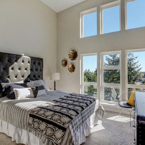 a bedroom with a large bed and a large window