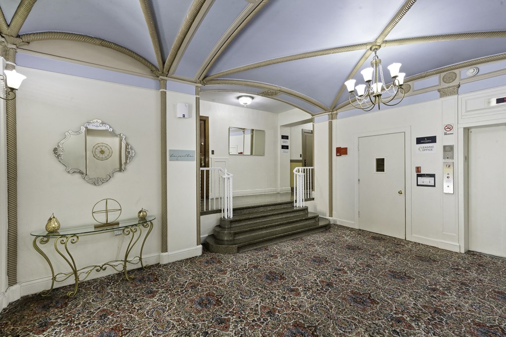 a large lobby area with blue vaulted ceilings with intricate gold detailing and a chandelier at Stockbridge Apartment Homes, Washington, 98101