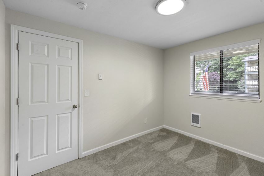 Living Room with a white door and a window Living Room with a white door and a window at Swiss Gables Apartment Homes, Kent, Washington 98032 - Photo Gallery