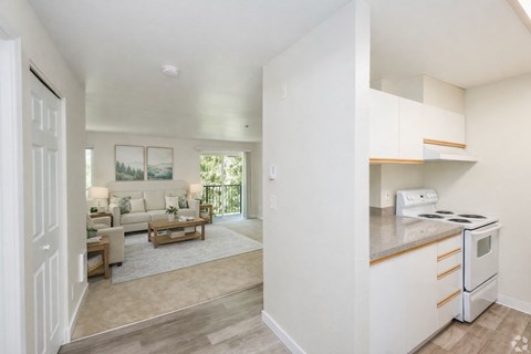 A white kitchen with a stove and a countertop.