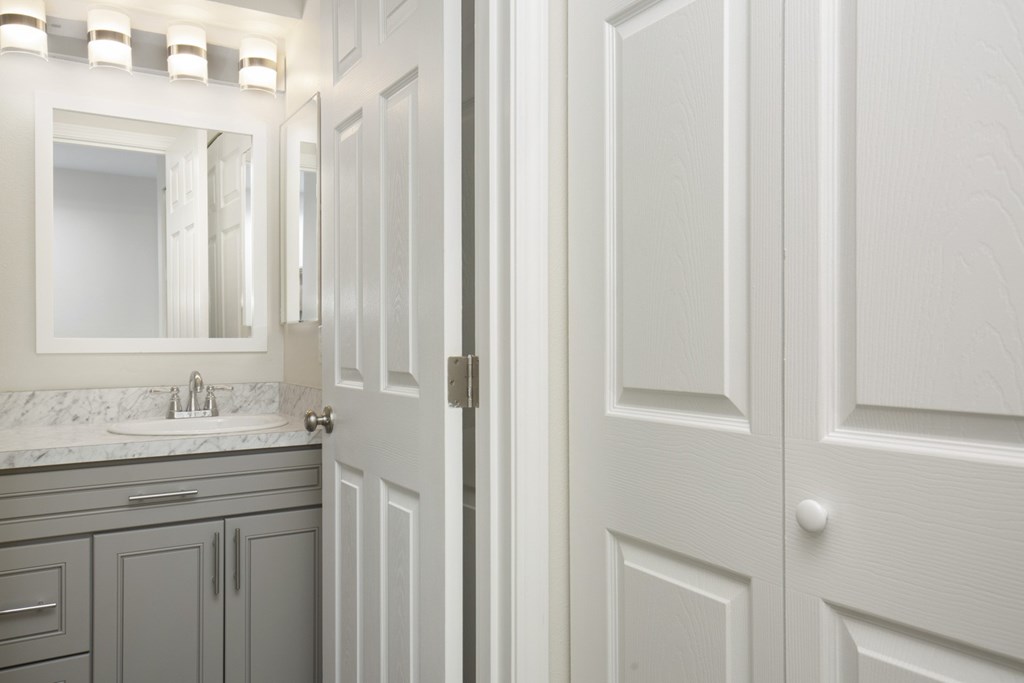 A white door is open to a bathroom.