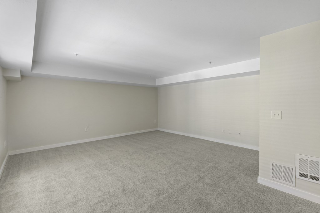 Spacious Living Room with a Plushily Carpeted Floor and Beige Walls at Excalibur Apartment Homes, Bellevue, 98004