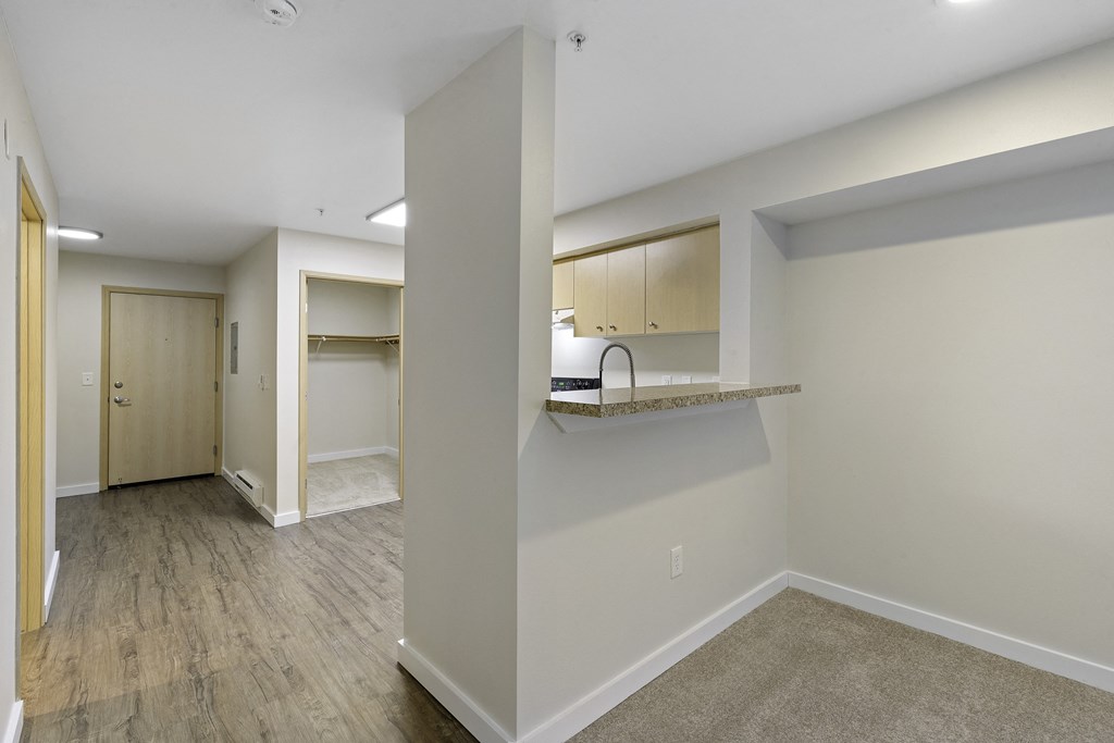 Living Room View with Breakfast Bar and Plank Flooring at Excalibur Apartment Homes, Washington, 98004
