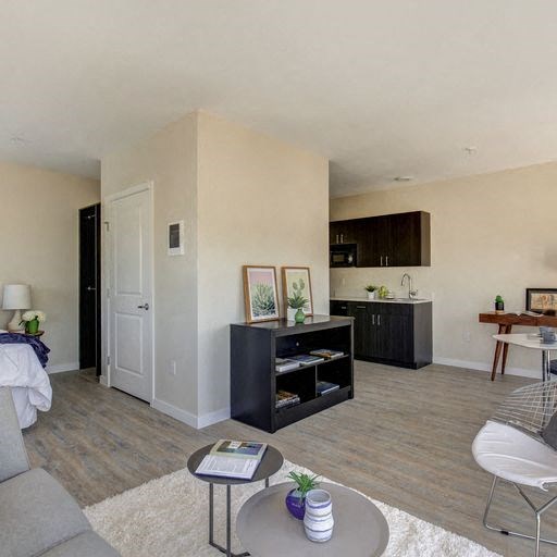 a living room with a couch a table and a chair