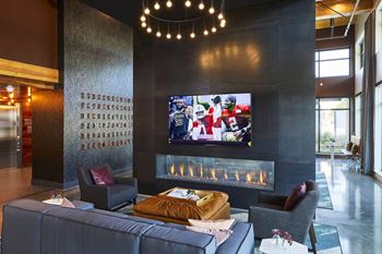 Lounge with Fireplace & Big Screens at Postmark Apartments, Shoreline Washington