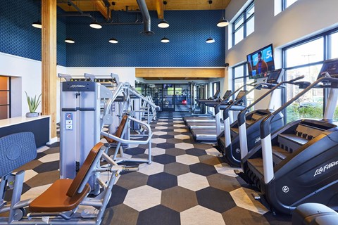 A gym with treadmills and exercise equipment.at Postmark Apartments, Shoreline