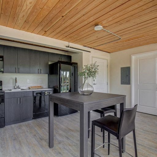a kitchen and dining room with a wooden ceiling
