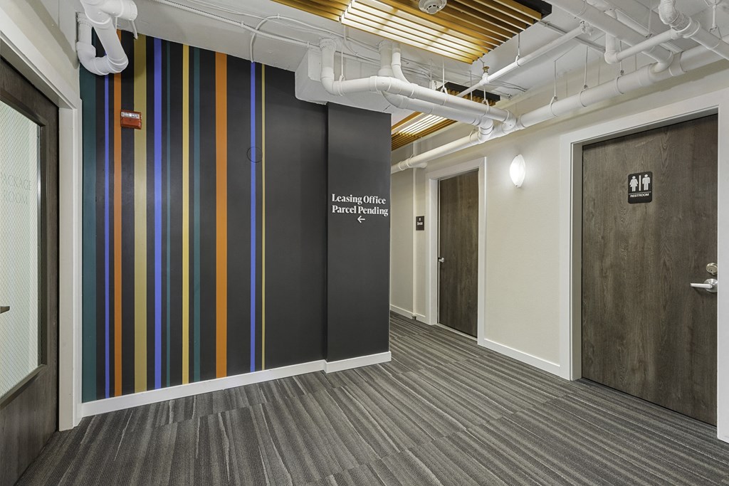 Corridor with Wall Art with a white lettering on it at Sir Gallahad Apartment Homes, Bellevue, Washington 98004