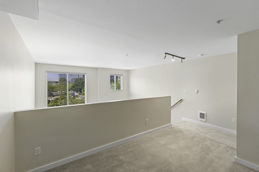 Second Floor Loft Bedroom with Large Windows and Plush Carpet Flooring at Sir Gallahad Apartment Homes, WA 98004