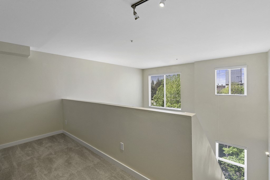 Loft-Style Bedroom with Wall to Wall Carpeting, and Multiple Window Views Loft-Style Bedroom with Wall to Wall Carpeting, and Multiple Window Views at Sir Gallahad Apartment Homes, Bellevue, 98004