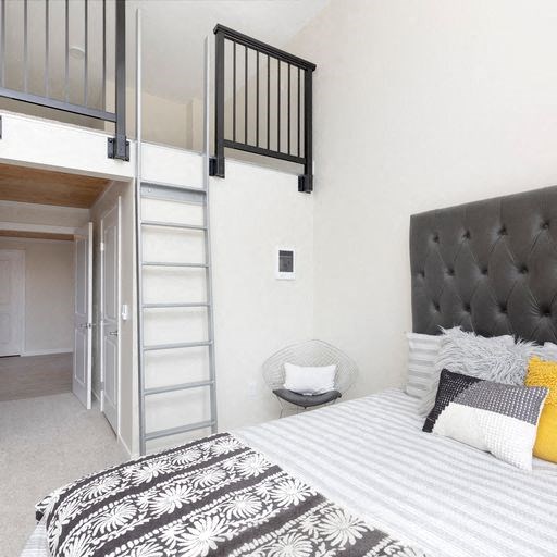 a bedroom with a bed and a lofted bed