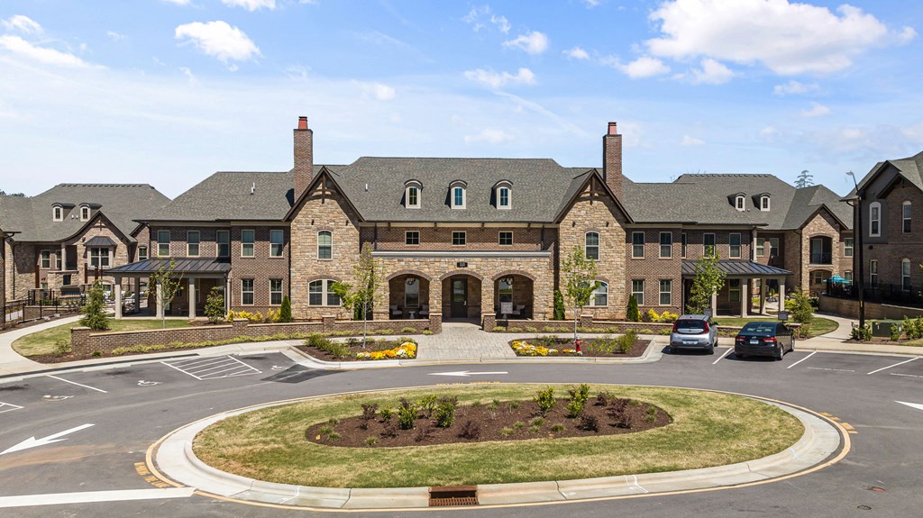 a large brick building with two chimneys and a roundabout in front of it at Griffin Weston, North Carolina, 27513