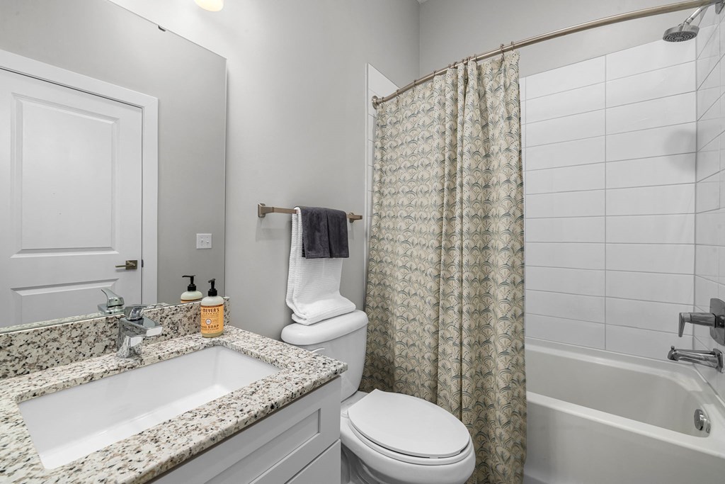 a bathroom with gray walls and a white sink and toilet  at Griffin Weston, Cary, North Carolina