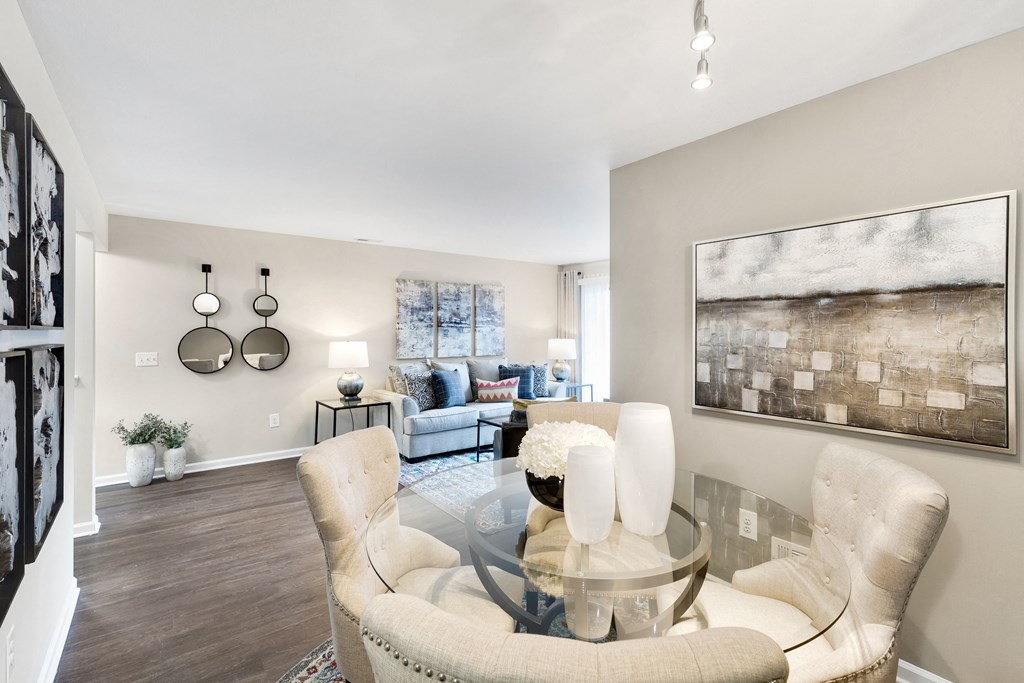 a living room with a glass table and chairs  at Northridge, Rochester Hills, MI
