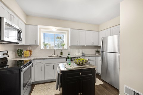 a kitchen with stainless steel appliances and white cabinets